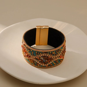 Vista macro de pulsera ancha bohemia con cierre magnético dorado y piedras turquesas