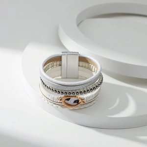 Detail van meerlagige armband met luipaard hanger, strassteentjes en magneetsluiting