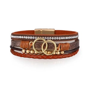 Close-up of bohemian multilayer leather bracelet with gold rings and magnetic clasp