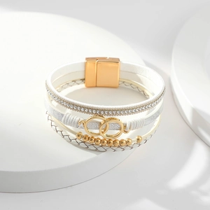 Detail showing the white multilayer leather bracelet with crystal rhinestones and magnetic clasp