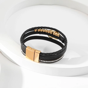 Detail of multi-layer leather bracelet with gold beads and sparkling crystal pave inlay
