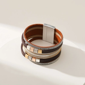 Detail of multi-layer leather bracelet featuring rhinestone edges and magnetic clasp