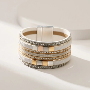 Detail of multi-layer leather bracelet featuring rhinestone chains and magnetic clasp