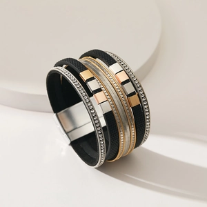 Detail of wide multi-layer leather bracelet with rhinestone bands and magnetic clasp
