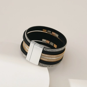 Detail of multi-layer wide leather bracelet featuring rhinestones and magnetic clasp