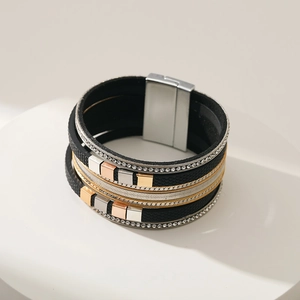 Macro shot of multi-layer leather bracelet featuring rhinestone edges and a magnetic clasp