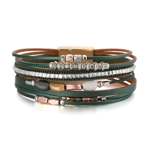 Detailed close-up of Bohemian multilayer leather bracelet with leaf charms and magnetic clasp