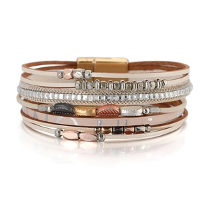 Detail of bohemian wrap bracelet with leather bands, metal leaf charms, and magnetic clasp
