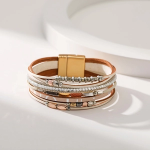 Detail of bohemian multilayer leather bracelet featuring metallic beads and magnetic clasp