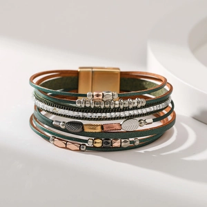 Detail of bohemian multilayer leather bracelet with leaf charms and magnetic clasp