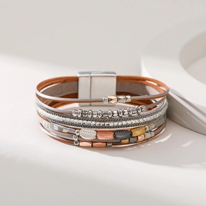 Detail of bohemian multilayer leather bracelet with metal leaves and magnetic clasp