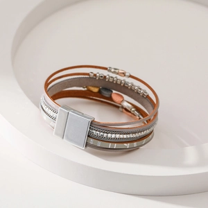 Detail of bohemian layered leather bracelet with rhinestone bands and magnetic clasp