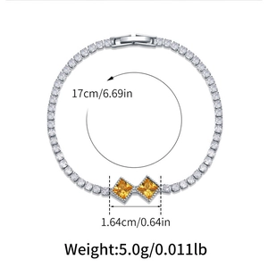 Detail of silver tennis bracelet with cubic zirconia and yellow square gemstone accents