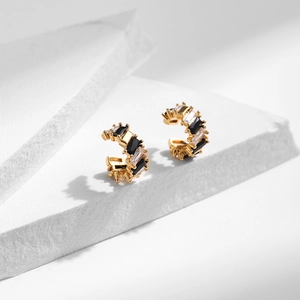 Modern C-shaped ear cuffs with black and white stone inlays on gold base