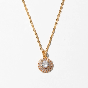 Detail shot of golden sunflower pendant necklace with sparkling crystal halo setting