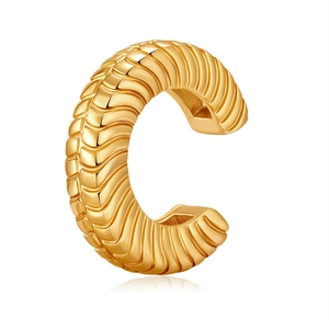 Detailed close-up of a gold-plated ear cuff with a spiral textured wavy design