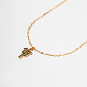 Detailed macro view of the cactus pendant featuring vibrant green and red cubic zirconia