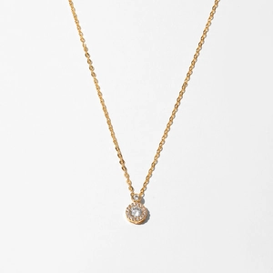 Close-up of gold starfish necklace featuring a double-layered pendant with sparkling gems