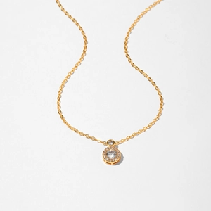 Close-up of golden starfish necklace with sparkling round halo zircon and delicate chain