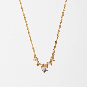 Detailed view of a gold-plated starfish necklace with sparkling white zircons and V-shaped pendant