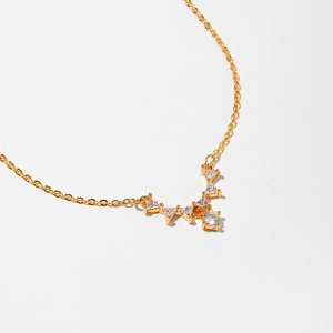 Detail of gold starfish necklace with V-shaped sparkling cubic zirconia pendants