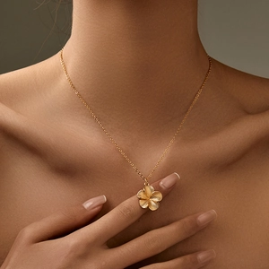 Golden starfish necklace with textured star pendant on a female model neck