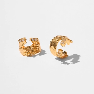 Detailed view of gold plated ear cuff with lava texture and sparkling white zircon stones
