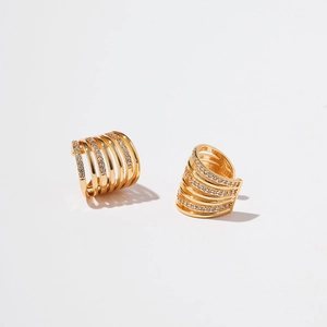 Macro detail of gold-plated multi-layer ear cuff with shimmering zircon stone inlays