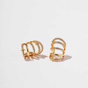Detail of gold-plated multi-layer ear cuff with cubic zirconia and star charms