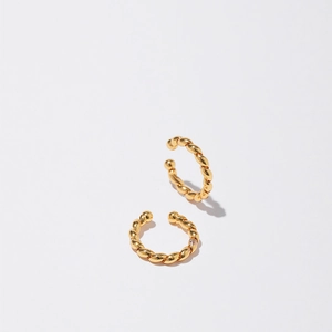 Detailed macro view of 18K gold plated twisted rope cuff earrings with zircons