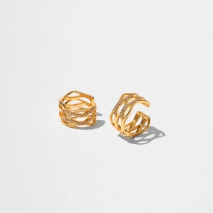 Macro detail of wave-textured gold plated ear cuffs with micro zircon crystal inlays