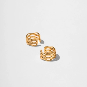 Detail of 18K gold-plated ear cuffs featuring hollow wave texture and inlaid zircons