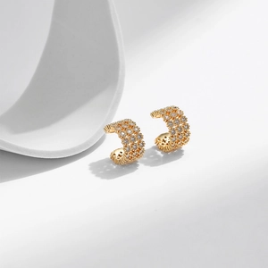 Close-up of 18K gold plated C-shaped ear cuffs with micro-set shimmering cubic zirconia