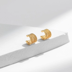 Detail of minimalist 18K gold plated brass ear cuffs with layered four-row bead design