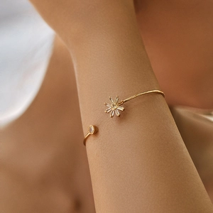 Close-up of 18K gold plated brass open bangle featuring sparkling leaf and zircon accents