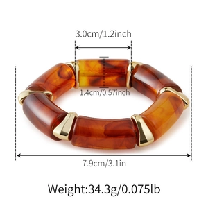 Detail of amber resin chunky bracelet with marble pattern and gold metal spacers