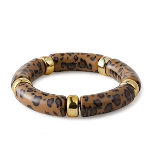 Detail of acrylic leopard print bracelet segments joined by polished gold metal rings