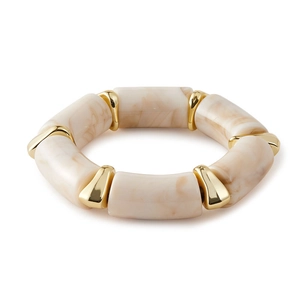 Detail of acrylic amber bangle with cream marble texture and gold metal joints