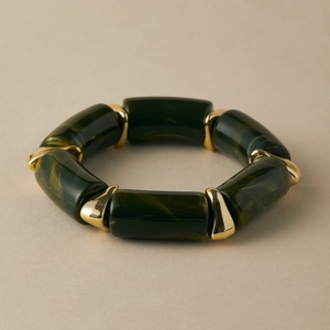 Close-up of green marble resin bracelet featuring gold polished metal connectors