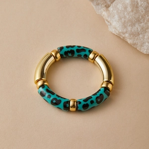Detail of bohemian stretch bracelet with blue leopard beads and gold metal tubes