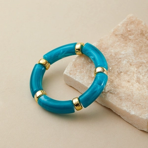 Detail of bohemian blue marble resin stretch bracelet with gold metallic spacer beads