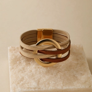 Détail d'un bracelet bohème multicouche en cuir avec anneau doré et fermoir magnétique