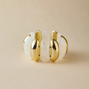 Detail view of wide elastic bracelet with gold metal and marble acrylic resin blocks