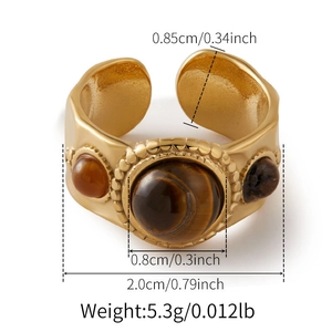 Macro detail of retro wide gold ring with tiger eye stone and beaded edge details