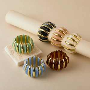 Handmade beaded acrylic bangles with color-blocking and golden metal accents