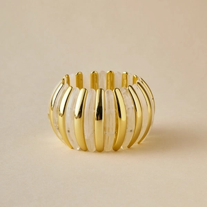 Detail of bohemian acrylic marble resin and gold metal beads on elastic bracelet