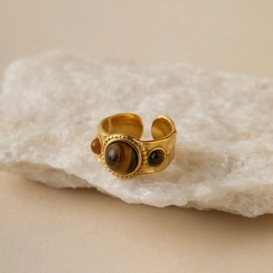 Detailed view of bohemian vintage gold ring with tiger eye stone and hammered metal texture