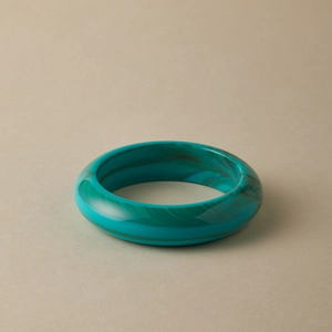 Detailed view of wide turquoise marble pattern acrylic bangle with retro textures