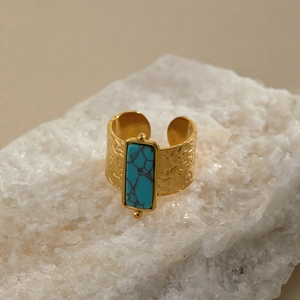 Close-up of vintage gold hammered ring featuring a rectangular turquoise stone inlay