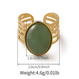 Detail view of bohemian gold ring showing large green stone and textured band